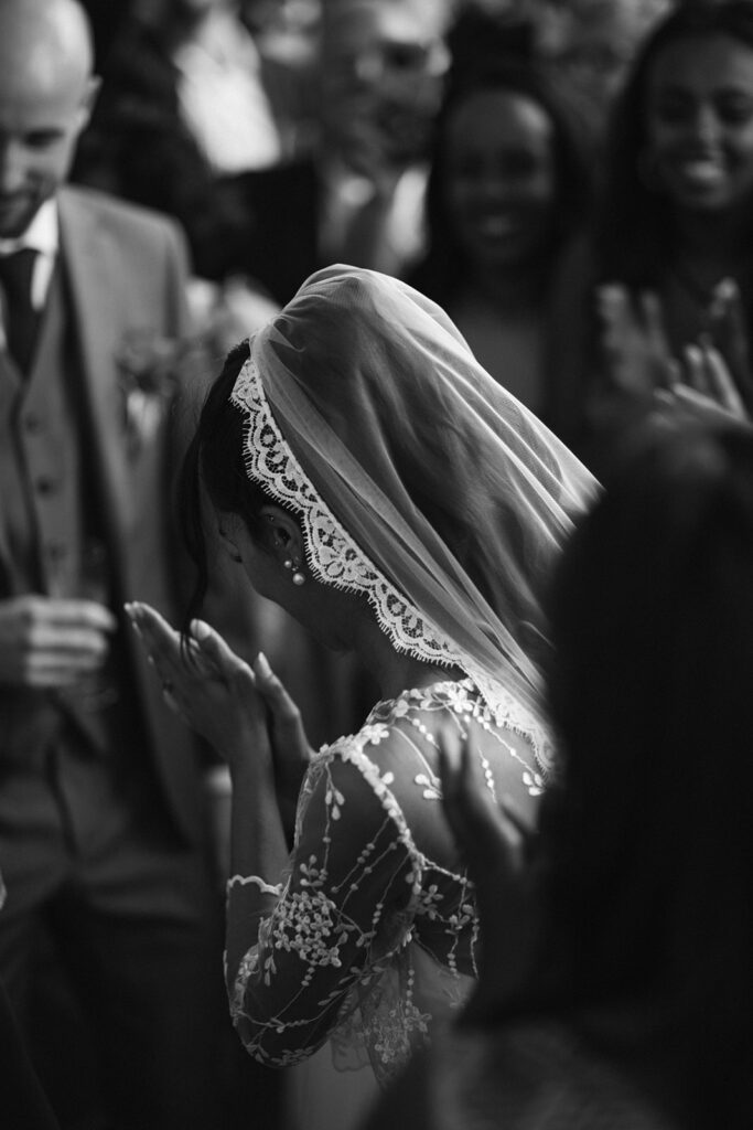 Bride prays during her spiritual wedding ceremony. Black and white high quality photo